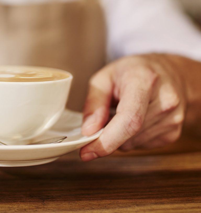 Barista serving cup of fresh coffee for you
