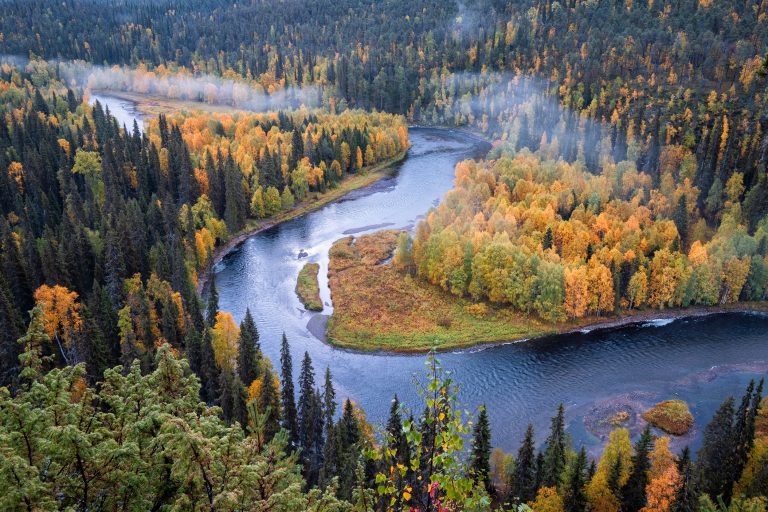 Kuusamo Joki mutkittelee ruskaisen metsän keskellä.